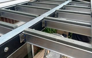 Work in progress of installation of an aluminium subframe of a balcony
