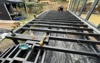 Work in progress of the subframe for Millboard decking in Golden Oak being installed