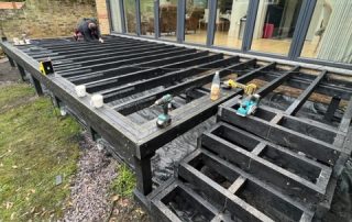 Work in progress of the subframe for Millboard decking in Golden Oak being installed