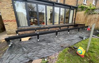 Work in progress of the subframe for Millboard decking in Golden Oak being installed