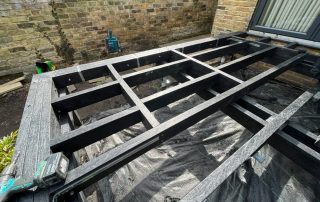 Work in progress of the subframe for Millboard decking in Golden Oak being installed