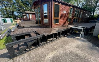 Work in progress of brown composite decking being installed surrounding a static home