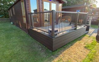 Dark brown Neotimber decking installed surrounding a static home