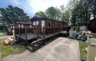 Brown composite decking installed surrounding a static home