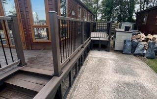 Brown composite decking installed surrounding a static home