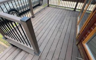 Brown composite decking installed surrounding a static home