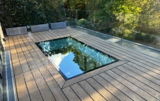 Decking installed surrounding a skylight to create a terrace area