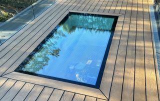 Decking installed surrounding a skylight to create a terrace area