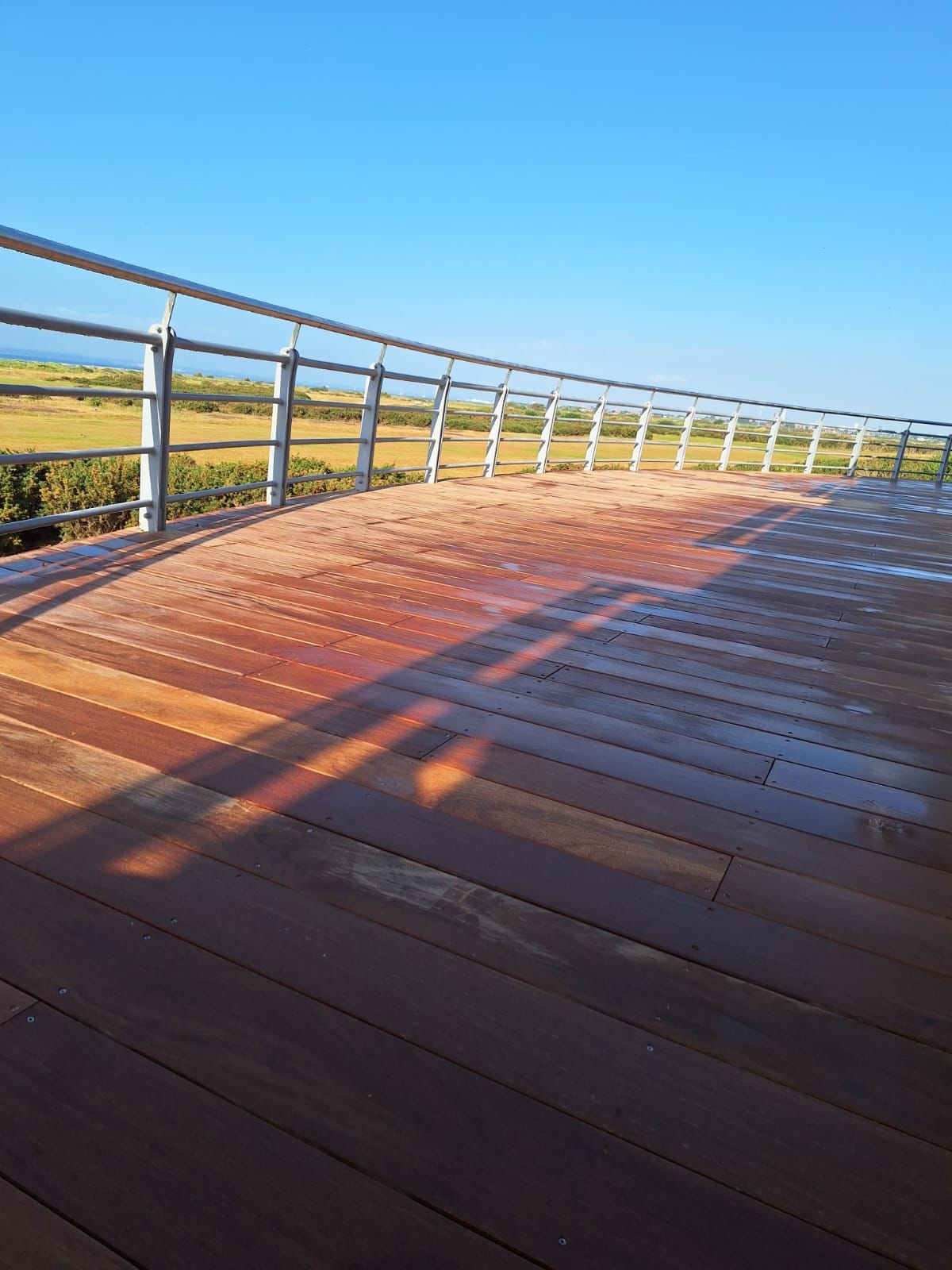 Hayling Island, Hampshire – Hayling Golf Club – Cumaru Wooden Decking 5 Low view of composite decking installed on a balcony at a golf club on Hayling Island