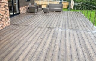 Millboard Composite Decking in Antique Oak Waterlooville 14 Standing view of a large composite decking porch installed to a house in Waterlooville