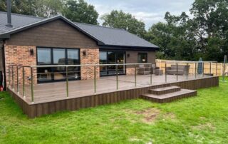 Millboard Composite Decking in Antique Oak Waterlooville 15 Far view of large composite decking porch installed to a house in Waterlooville