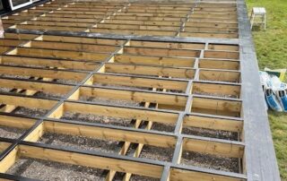 Millboard Composite Decking in Antique Oak Waterlooville 2 Wooden scaffolding work in progress to create a composite decking porch in Waterlooville