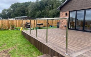Millboard Composite Decking in Antique Oak Waterlooville 3 View from the stairs of a large composite decking porch installed to a house in Waterlooville