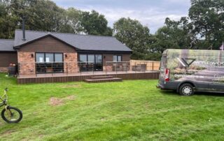 Millboard Composite Decking in Antique Oak Waterlooville 7 Far view of the whole house with a large composite decking porch in Waterlooville