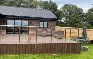 Millboard Composite Decking in Antique Oak Waterlooville 8 Close shot of a large composite decking porch installed to a house in Waterlooville