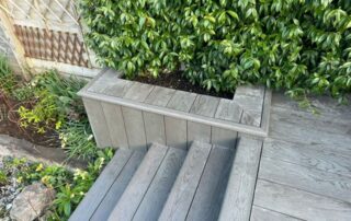 Millboard Composite Decking in Ebony Grey – Arundel, West Sussex 3 Close up of composite decking stairs installed forming stairs off of the porch in a garden in Arundel