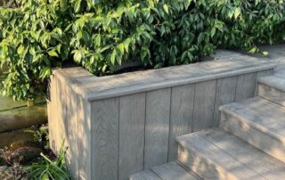 Millboard Composite Decking in Ebony Grey – Arundel, West Sussex 7 Close up of decking installed forming stairs off of the porch in a garden in Arundel