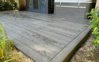 Millboard Composite Decking in Ebony Grey Farnham 1 Composite decking installed to a garden in Farnham