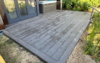 Millboard Composite Decking in Ebony Grey Farnham 3 Composite decking installed to a garden in Farnham