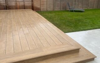 Millboard Composite Decking in Golden Oak Horley 2 Composite decking installed to a garden in Farnham