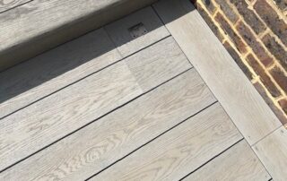 Millboard Composite Decking in Smoked Oak Farnham 9 Standing view of composite decking installed in Farnham